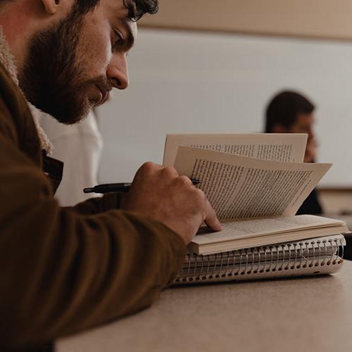 A student reads a book in class